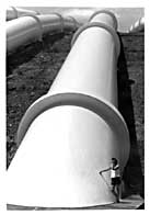 Patrycja standing next to a HUGE pipe at Tumut Power Station